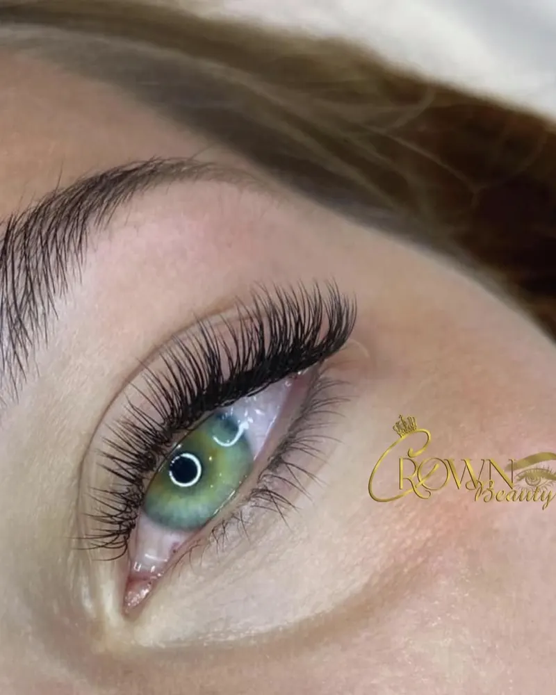 Natural wispy lash extensions on green eyes